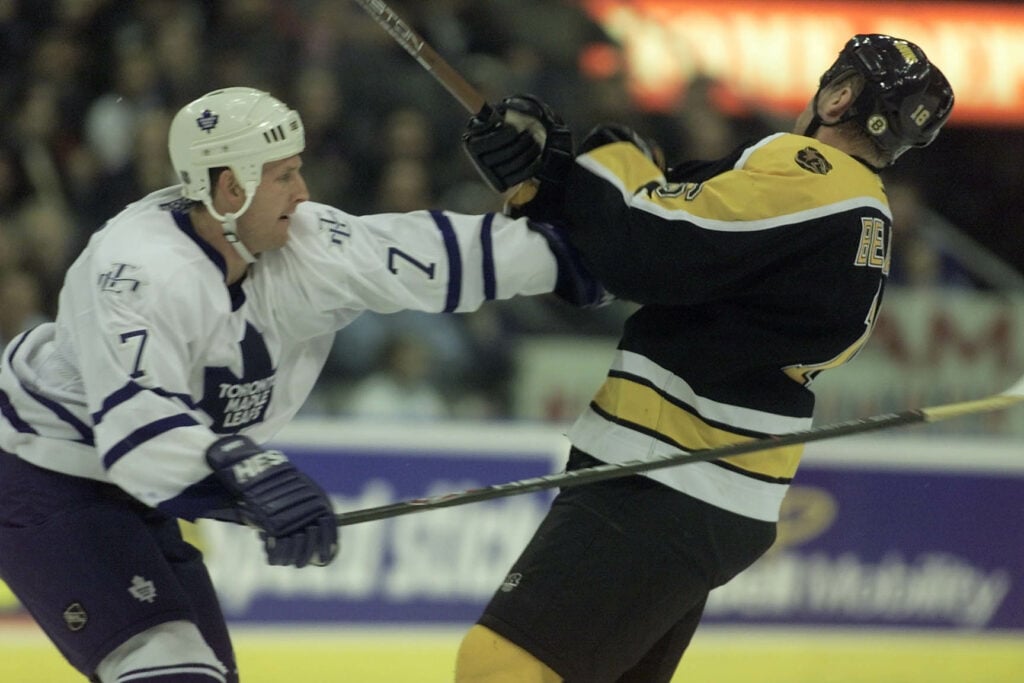 RUSS // Gary Roberts of the Toronto Maple Leafs gives Ken Belanger of the Boston Bruin