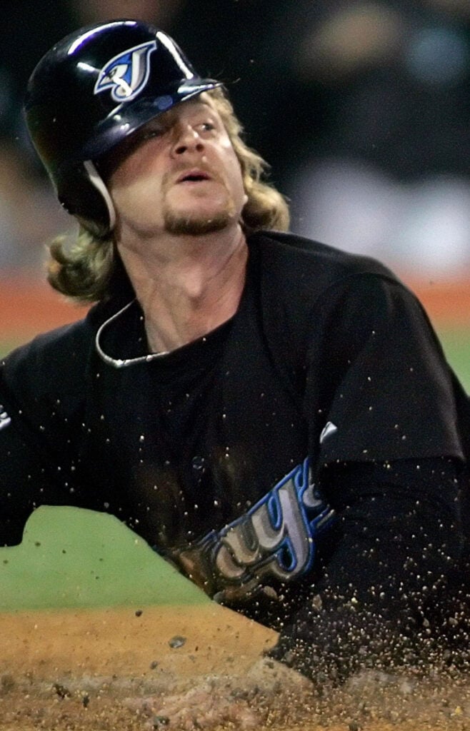 Toronto Blue Jays' Gregg Zaun looks up at the umpire for the call after sliding safely into home in Toronto